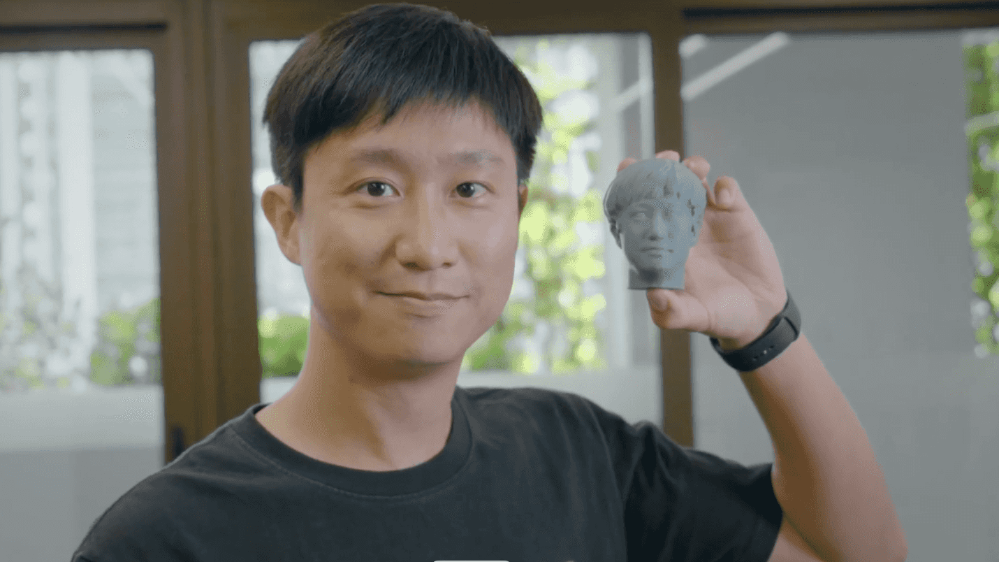 Person holding a 3D printed head model created with KIRI Engine — example of a scan-to-print workflow using the Basic free plan